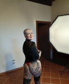 Italian girl with shaved hair, tattoos and dangerous curves